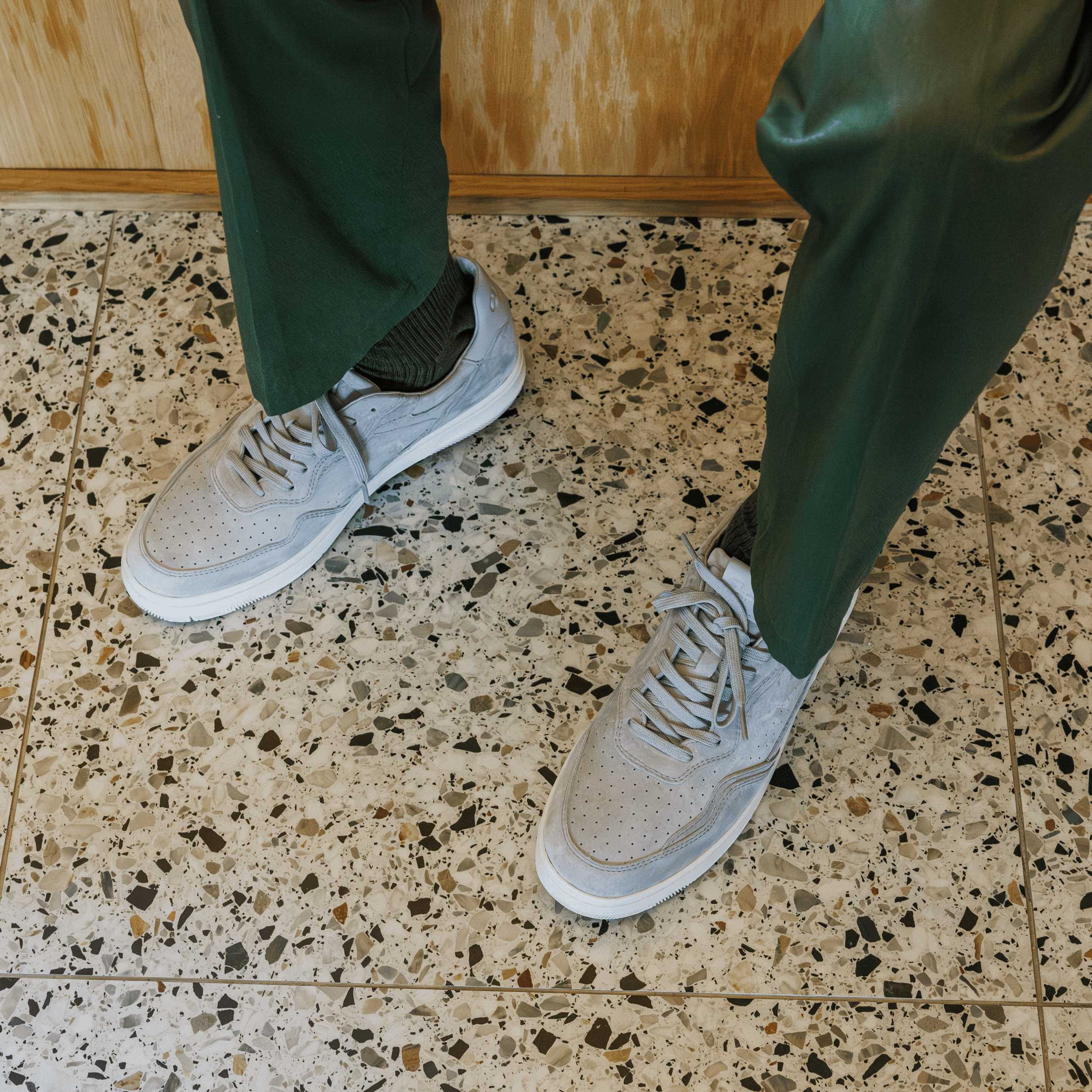 Haywood court shoe in Quiet Gray Suede worn in casual lifestyle setting, highlighting premium materials and refined detailing.