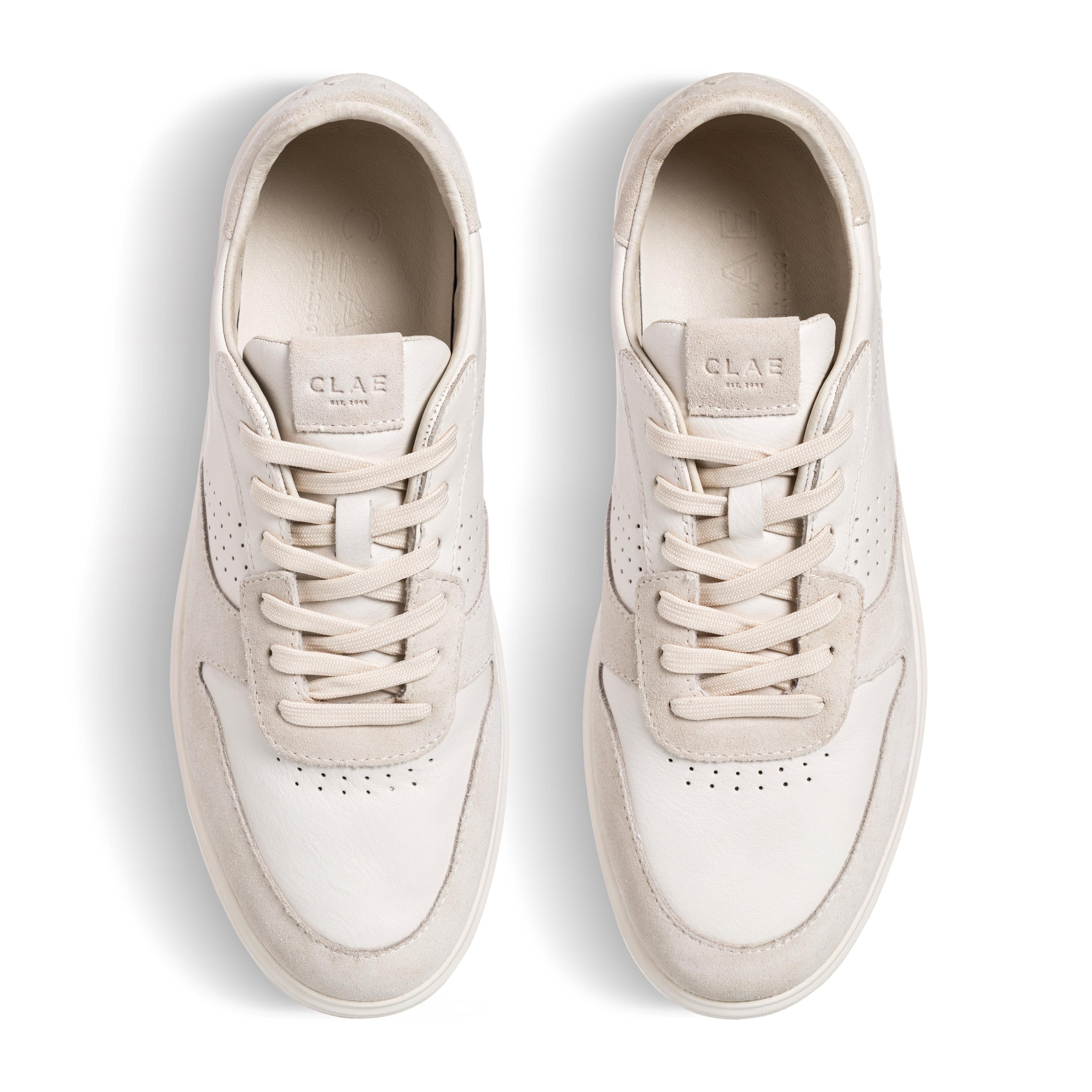 Three-quarter view of Moses sneaker in Triple Off-White, highlighting premium materials and All Court (AC) outsole construction.