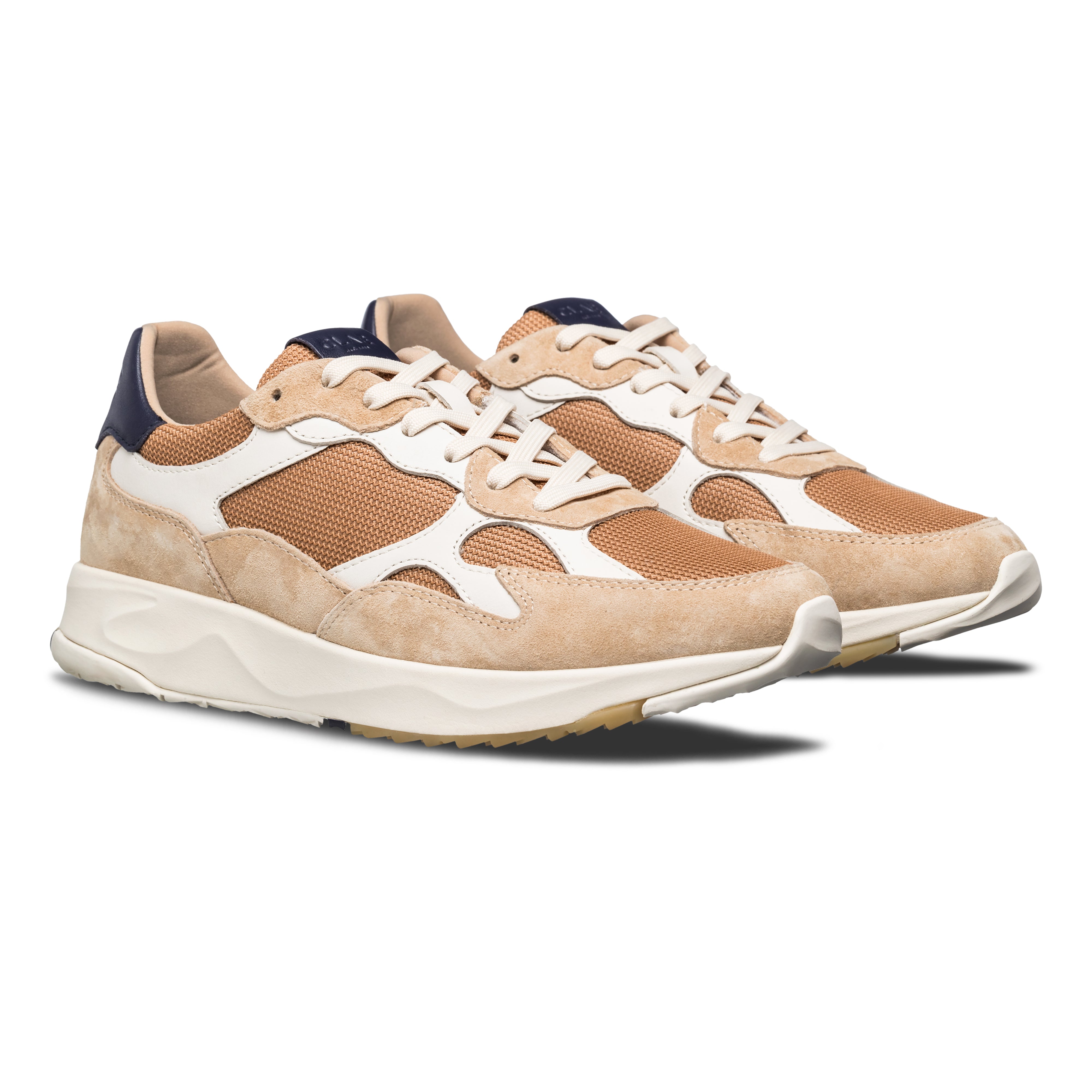 Three-quarter view of Zuma runner in Safari Doe Navy, highlighting flexible construction and Desert Track outsole design.
